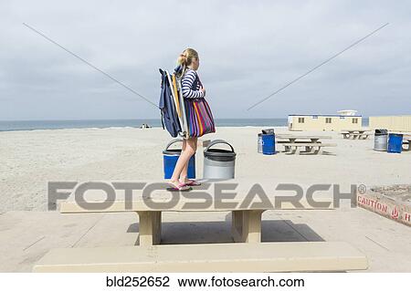 Caucasian girl standing on picnic table at beach View Large Photo Image Stock Image - Caucasian girl standing on picnic table at beach. Fotosearch
