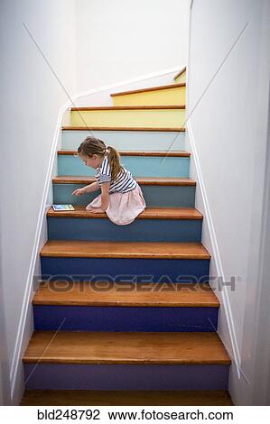 Caucasian girl using digital tablet on multicolor staircase View Large Photo Image Stock Image - Caucasian girl using digital tablet on multicolor staircase. Fotosearch