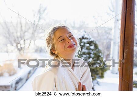 Stock Photo - Caucasian girl wearing bathrobe laughing. Fotosearch