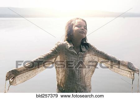 Caucasian girl wearing wet shirt near sunny lake View Large Photo Image Stock Photo - Caucasian girl wearing wet shirt near sunny lake. Fotosearch