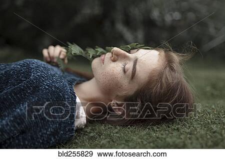 Caucasian girl with freckles laying in grass View Large Photo Image Stock Photo - Caucasian girl with freckles laying in grass. Fotosearch