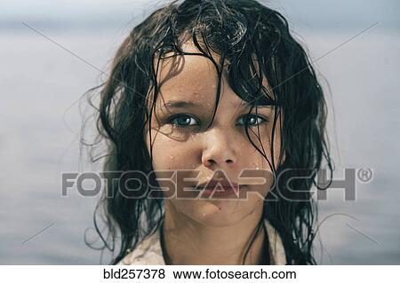 Stock Photo - Caucasian girl with wet hair near lake. Fotosearch