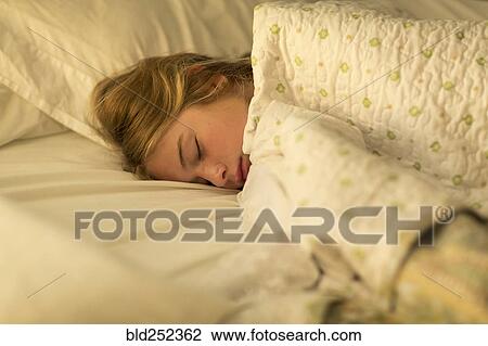 Caucasian girls sleeping in bed under blanket View Large Photo Image Stock Image - Caucasian girls sleeping in bed under blanket. Fotosearch