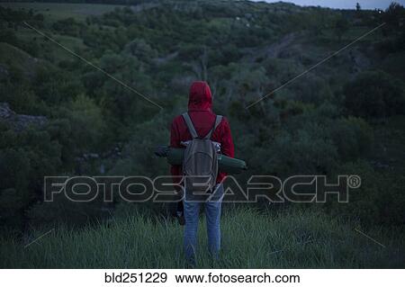 Caucasian hiker standing in grass View Large Photo Image Stock Photo - Caucasian hiker standing in grass. Fotosearch