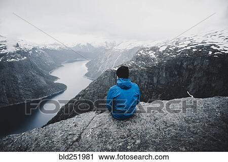 Stock Image - Caucasian man admiring scenic view of mountain river. Fotosearch