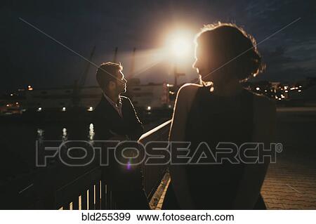Caucasian man and woman at waterfront at night View Large Photo Image Stock Photo - Caucasian man and woman at waterfront at night. Fotosearch