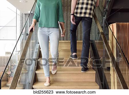 Caucasian man and woman passing on staircase View Large Photo Image Stock Image - Caucasian man and woman passing on staircase. Fotosearch