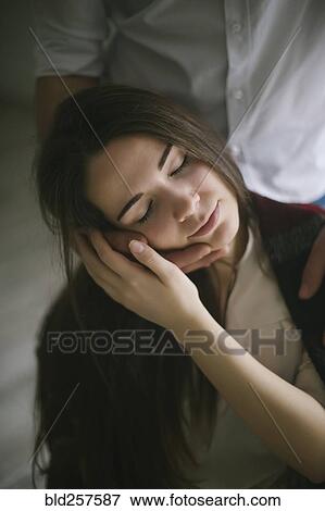 Stock Photo - Caucasian man caressing face of woman. Fotosearch