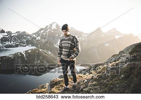 Caucasian man carrying camera near mountain lake View Large Photo Image Stock Image - Caucasian man carrying camera near mountain lake. Fotosearch