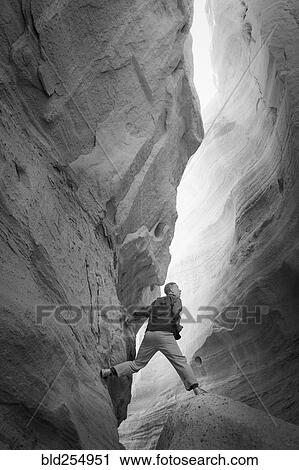 Caucasian man climbing rock formation View Large Photo Image Stock Image - Caucasian man climbing rock formation. Fotosearch