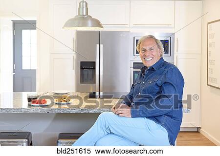 Caucasian man drinking juice in kitchen View Large Photo Image Stock Photography - Caucasian man drinking juice in kitchen. Fotosearch