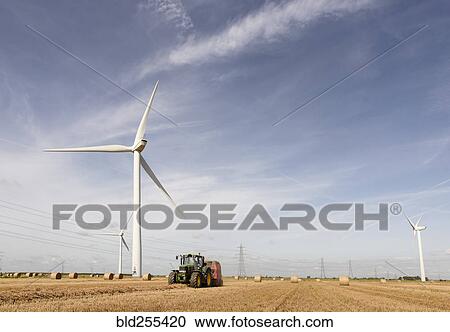 Caucasian man driving tractor near wind turbines View Large Photo Image Stock Image - Caucasian man driving tractor near wind turbines. Fotosearch