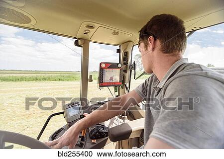 Caucasian man driving tractor on farm View Large Photo Image Stock Image - Caucasian man driving tractor on farm. Fotosearch