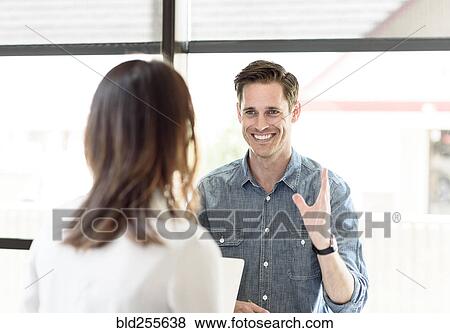 Stock Photo - Caucasian man gesturing to woman. Fotosearch