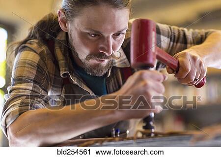 Caucasian man hammering leather View Large Photo Image Stock Image - Caucasian man hammering leather. Fotosearch