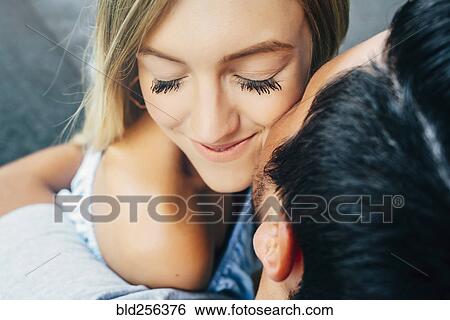 Caucasian man hugging woman and kissing her on cheek View Large Photo Image Stock Photograph - Caucasian man hugging woman and kissing her on cheek. Fotosearch