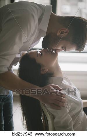 Caucasian man kissing woman in chair View Large Photo Image Stock Image - Caucasian man kissing woman in chair. Fotosearch