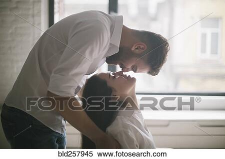 Caucasian man kissing woman in chair View Large Photo Image Stock Photography - Caucasian man kissing woman in chair. Fotosearch