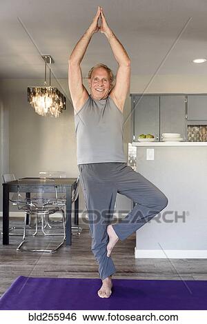 Caucasian man practicing yoga in home View Large Photo Image Stock Photograph - Caucasian man practicing yoga in home. Fotosearch