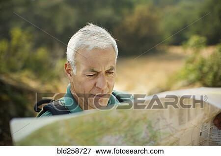 Stock Photo - Caucasian man reading map. Fotosearch