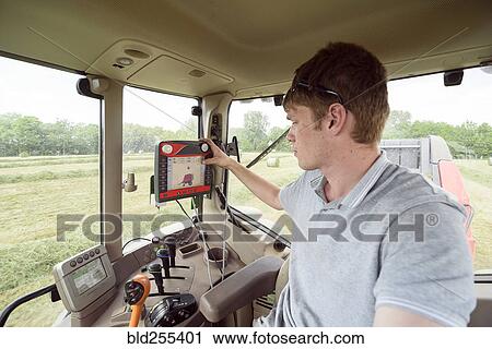 Caucasian man setting control panel in tractor on farm View Large Photo Image Stock Image - Caucasian man setting control panel in tractor on farm. Fotosearch