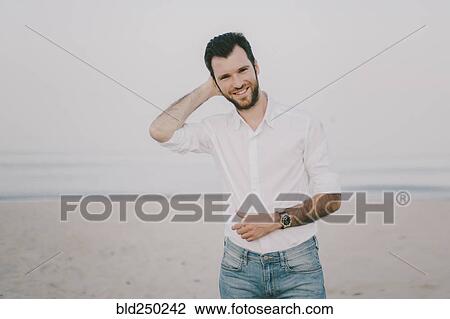 Caucasian man standing on beach View Large Photo Image Stock Image - Caucasian man standing on beach. Fotosearch
