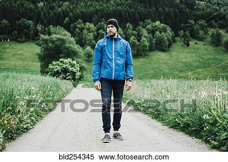 Caucasian man standing on dirt path View Large Photo Image Stock Photography - Caucasian man standing on dirt path. Fotosearch