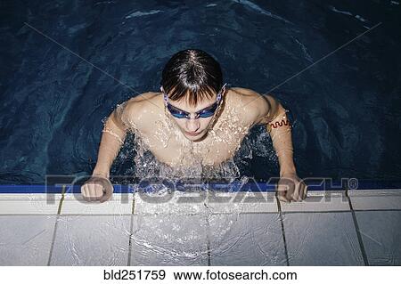 Caucasian man wearing goggles in swimming pool View Large Photo Image Stock Photo - Caucasian man wearing goggles in swimming pool. Fotosearch