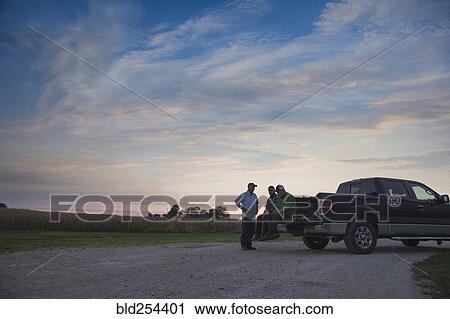 Caucasian men at pick-up truck at sunset View Large Photo Image Stock Image - Caucasian men at pick-up truck at sunset. Fotosearch