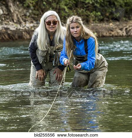 Caucasian mother and daughter fly fishing View Large Photo Image Stock Photograph - Caucasian mother and daughter fly fishing. Fotosearch