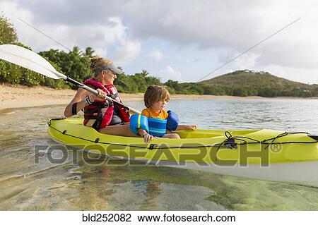 Stock Image - Caucasian mother and son in kayak. Fotosearch
