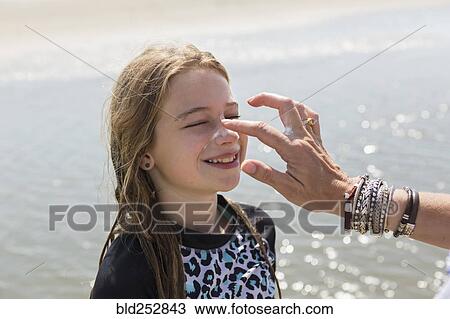 Caucasian mother applying sunblock to nose of daughter View Large Photo Image Stock Image - Caucasian mother applying sunblock to nose of daughter. Fotosearch