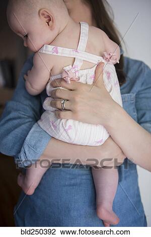 Caucasian mother holding baby daughter View Large Photo Image Stock Image - Caucasian mother holding baby daughter. Fotosearch