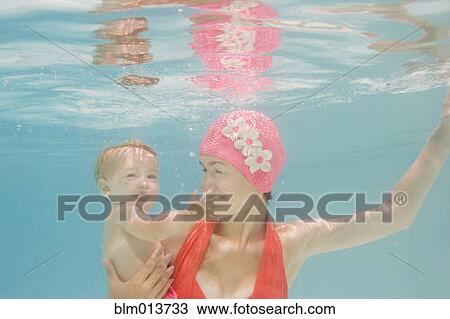 Caucasian mother holding baby underwater View Large Photo Image Stock Image - Caucasian mother holding baby underwater. Fotosearch