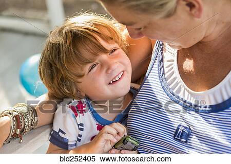 Caucasian mother hugging son holding toy car View Large Photo Image Stock Photography - Caucasian mother hugging son holding toy car. Fotosearch