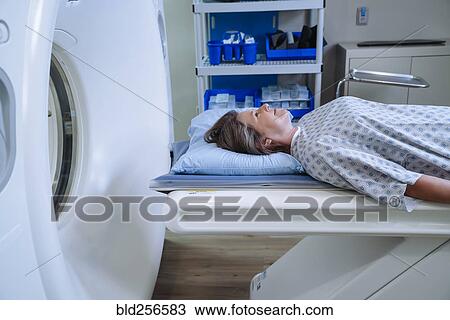 Caucasian patient laying on scanner table View Large Photo Image Stock Image - Caucasian patient laying on scanner table. Fotosearch