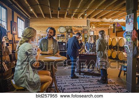 Stock Photography - Caucasian people drinking wine in winery. Fotosearch