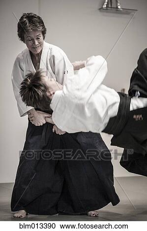 Stock Image - Caucasian people practicing martial arts. Fotosearch