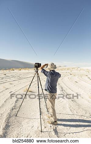 Caucasian photographer with tripod in desert View Large Photo Image Stock Image - Caucasian photographer with tripod in desert. Fotosearch