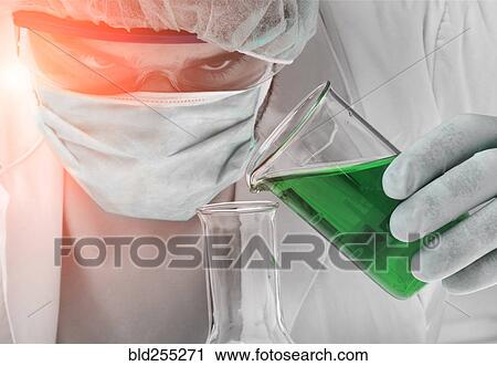 Caucasian scientist pouring green liquid into beaker View Large Photo Image Stock Image - Caucasian scientist pouring green liquid into beaker. Fotosearch