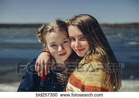 Caucasian sisters hugging on beach View Large Photo Image Stock Image - Caucasian sisters hugging on beach. Fotosearch