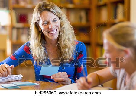 Caucasian teacher helping student in library with flash cards View Large Photo Image Stock Image - Caucasian teacher helping student in library with flash cards. Fotosearch