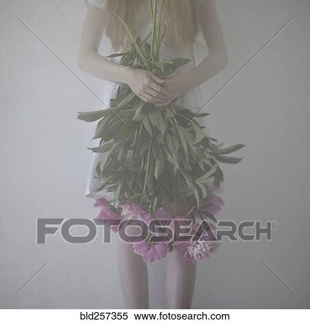 Caucasian teenage girl holding flowers upside-down View Large Photo Image Stock Photography - Caucasian teenage girl holding flowers upside-down. Fotosearch