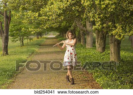 Caucasian teenage girl playing flute in park View Large Photo Image Stock Image - Caucasian teenage girl playing flute in park. Fotosearch
