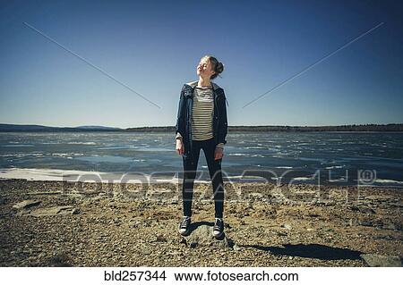 Caucasian teenage girl standing on sunny beach View Large Photo Image Picture - Caucasian teenage girl standing on sunny beach. Fotosearch