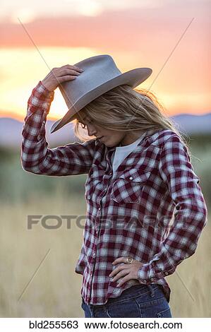 Caucasian teenage girl wearing cowboy hat at sunset View Large Photo Image Stock Image - Caucasian teenage girl wearing cowboy hat at sunset. Fotosearch