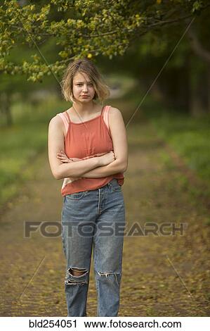 Caucasian teenage girl with arms crossed in park View Large Photo Image Stock Image - Caucasian teenage girl with arms crossed in park. Fotosearch
