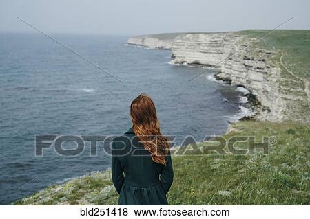 Stock Photo - Caucasian woman admiring ocean. Fotosearch