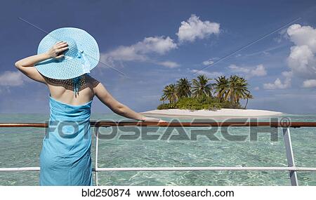 Caucasian woman admiring scenic view of island from boat View Large Photo Image Picture - Caucasian woman admiring scenic view of island from boat. Fotosearch