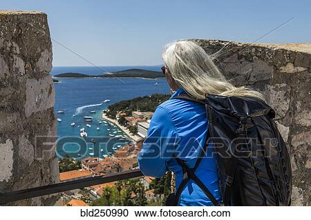 Caucasian woman admiring scenic view of ocean View Large Photo Image Stock Image - Caucasian woman admiring scenic view of ocean. Fotosearch